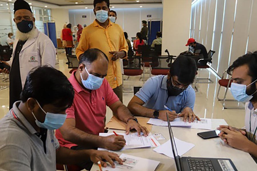 Migrant workers begin signing up for COVID-19 vaccine