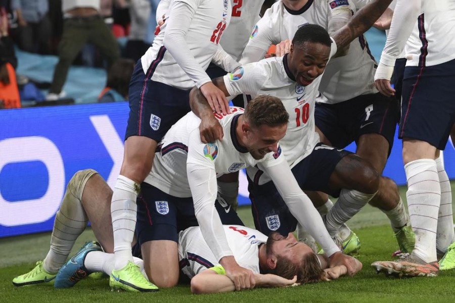 England's Harry Kane, bottom, celebrates with his teammates after scoring his side's second goal during the Euro 2020 soccer semifinal match between England and Denmark at Wembley stadium in London, Wednesday, July 7, 2021. (Laurence Griffiths/Pool Photo via AP)