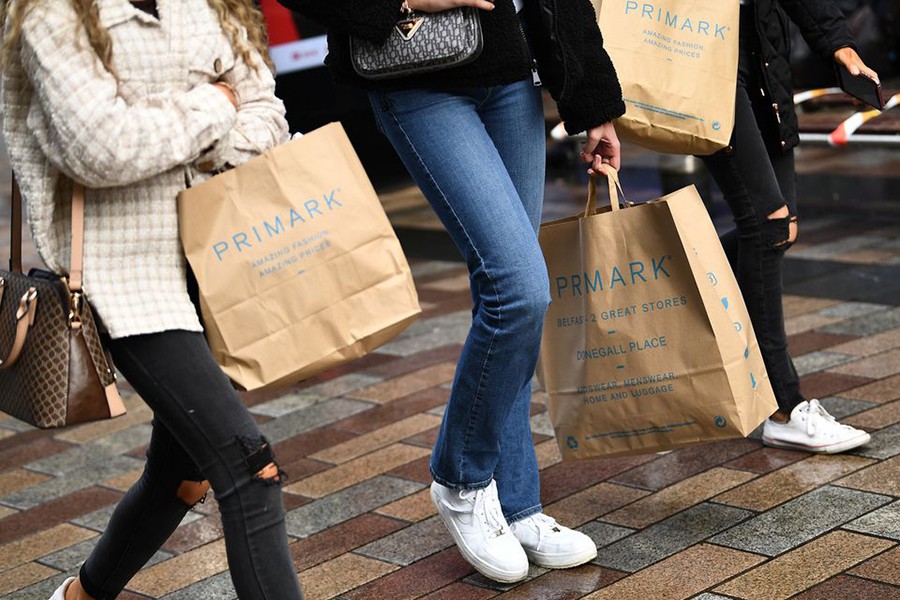 People carry Primark shopping bags after retail restrictions due to coronavirus disease (COVID-19) eased, in Belfast, Northern Ireland, May 4, 2021. REUTERS/Clodagh Kilcoyne