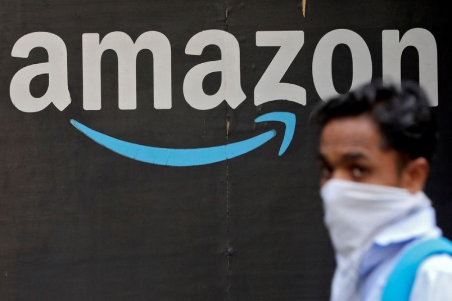 A man walks past an Amazon logo outside the company's collection point in Mumbai, India, March 19, 2021. REUTERS/Francis Mascarenhas