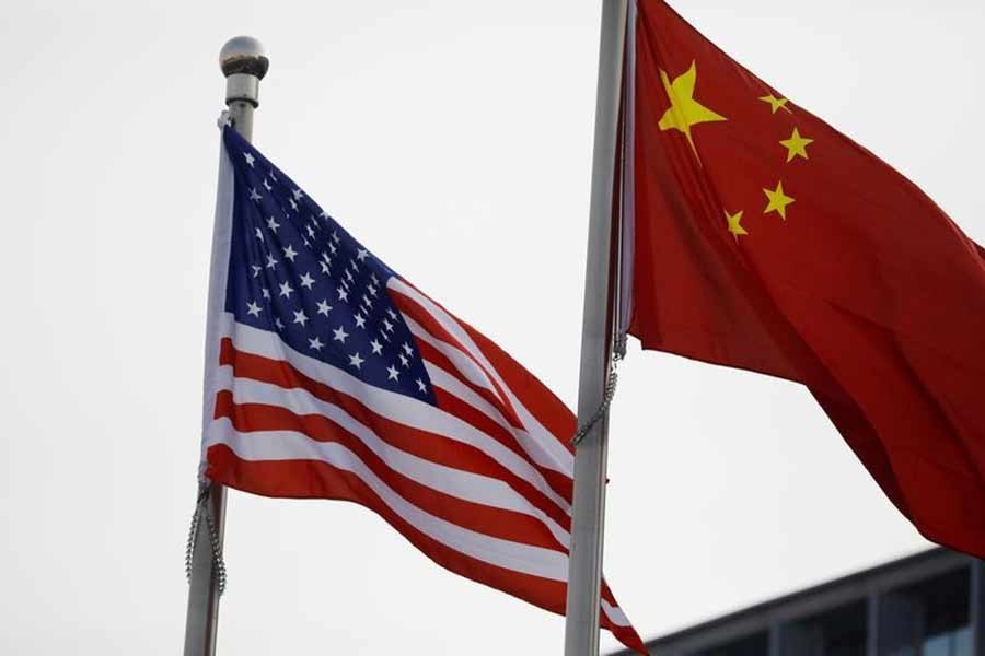 Chinese and US flags flutter outside a building — Reuters/Files