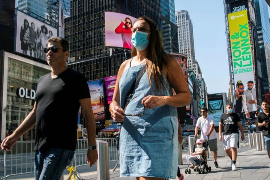 People wear masks around Times Square, as cases of the infectious coronavirus Delta variant continue to rise in New York City, New York, US on July 23, 2021 — Reuters/Files