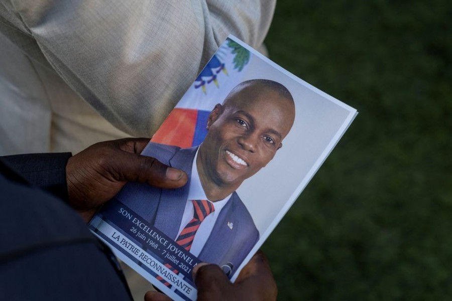 A person holds a photo of late Haitian President Jovenel Moise, who was shot dead earlier this month, during his funeral at his family home in Cap-Haitien, Haiti on July 23, 2021 — Reuters/Files