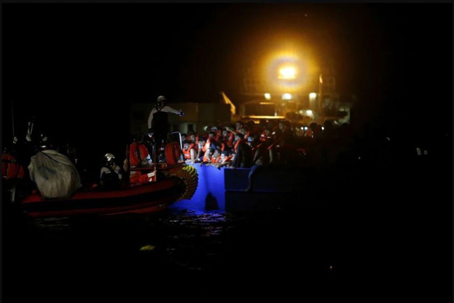 A RHIB (rigid hulled inflatable boat) from the French NGO SOS Mediterranee migrant rescue ship Ocean Viking approaches a wooden boat overcrowded with migrants, during a joint rescue operation with the German NGO migrant rescue ship Sea-Watch 3, in international waters off the coast of Tunisia, in the western Mediterranean Sea, August 1, 2021. REUTERS/Darrin Zammit Lupi