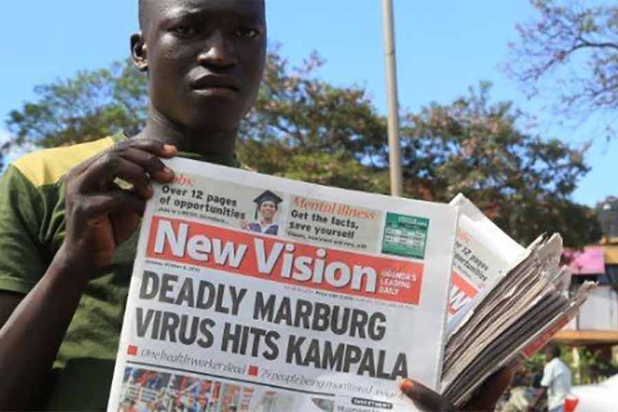 A news vendor displaying newspapers for sale along a street in the Ugandan capital Kampala in 2014 -Reuters file photo