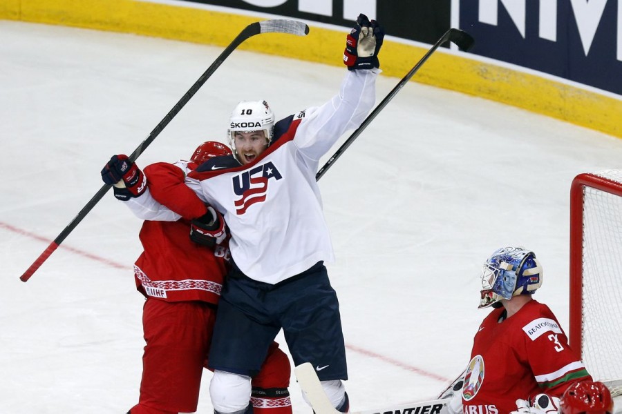 Jimmy Hayes of the US (L) celebrates the goal of team mate Jacob Trouba (unseen) against goalkeeper Andrei Mezin of Belarus (R) during the second period of their men's ice hockey World Championship Group B game at Minsk Arena in Minsk May 9, 2014. REUTERS/Alexander Demianchuk/File photo