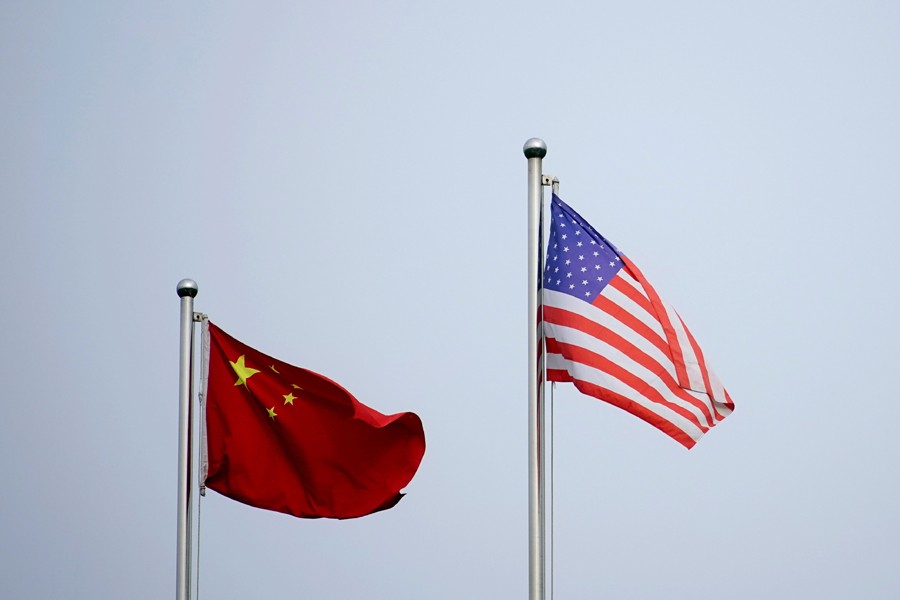 Chinese and US flags flutter outside a company building in Shanghai, China on April 14, 2021 — Reuters/Files