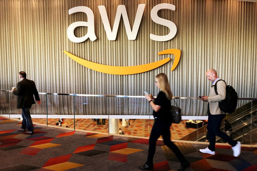 Attendees at Amazon.com annual cloud computing conference walk past the Amazon Web Services logo in Las Vegas, Nevada, US on November 30, 2017 — Reuters/Files