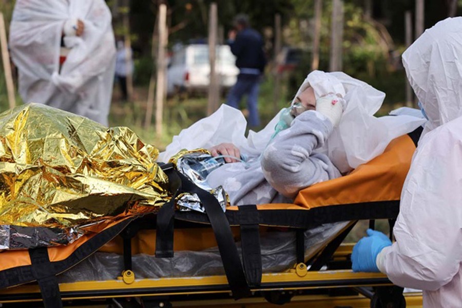 A COVID-19 patient, wounded in a fire that broke out at the intensive care unit of a COVID-19 hospital, is transported by medical professionals on a stretcher, in Constanta, Romania, Oct 1, 2021. Costin Dinca/ REUTERS