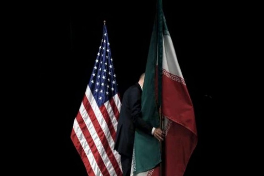 A staff member removes the Iranian flag from the stage after a group picture with foreign ministers and representatives of United States, Iran, China, Russia, Britain, Germany, France and the European Union during the Iran nuclear talks at the Vienna International Center in Vienna, Austria, July 14, 2015 -- Reuters/Carlos Barria