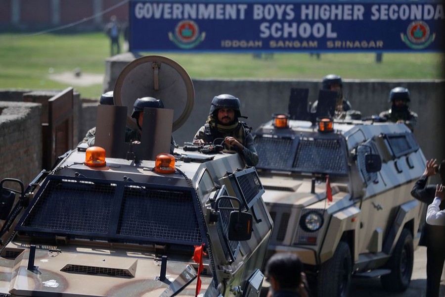 Indian security forces keep guard atop armoured vehicles, outside a government school after suspected militants shot and killed two teachers in Srinagar on October 7, 2021 — Reuters photo