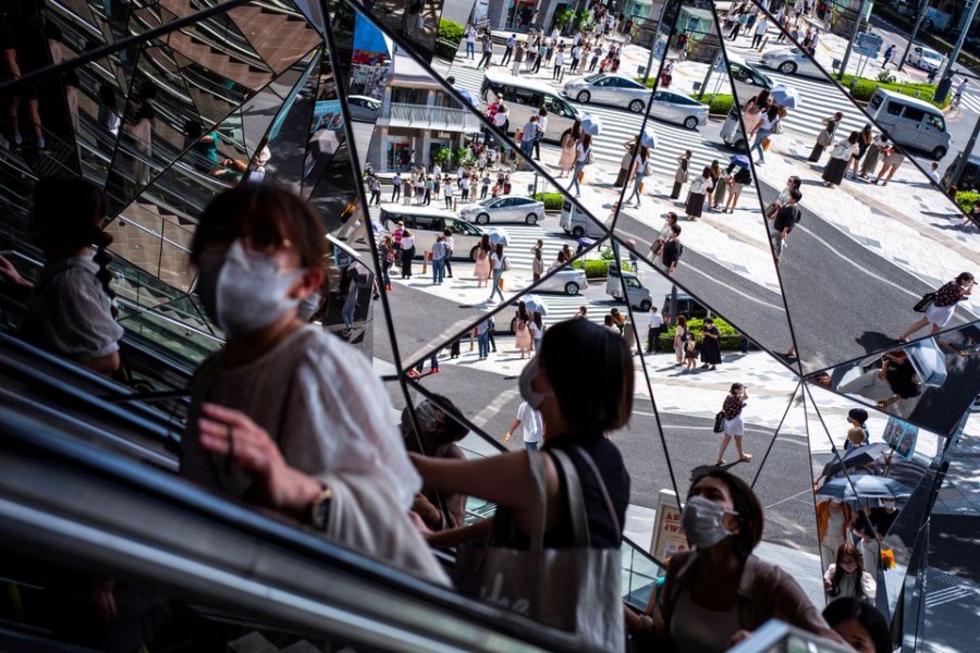 People wearing protective masks are reflected in the mirror at a shopping mall in Tokyo amid the coronavirus disease (Covid-19) outbreak in Tokyo, Japan on August 19, 2021 — Reuters/Files