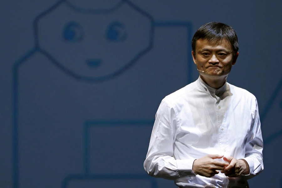 Jack Ma, founder and executive chairman of China's Alibaba Group, speaks in front of a picture of SoftBank's human-like robot named 'pepper' during a news conference in Chiba, Japan on June 18, 2015 — Reuters/Files