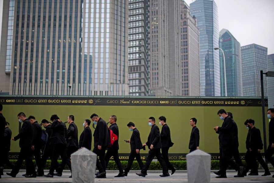 Security guards walk along at financial district of Lujiazui in Shanghai, China on October 15, 2021 — Reuters photo