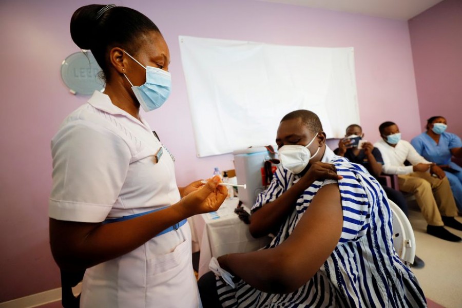 Medical officer Dr. Emmanuel Addipa-Adapoe, 42, receives the coronavirus disease (COVID-19) vaccine during the vaccination campaign at the Ridge Hospital in Accra, Ghana March 2, 2021. REUTERS/Francis Kokoroko