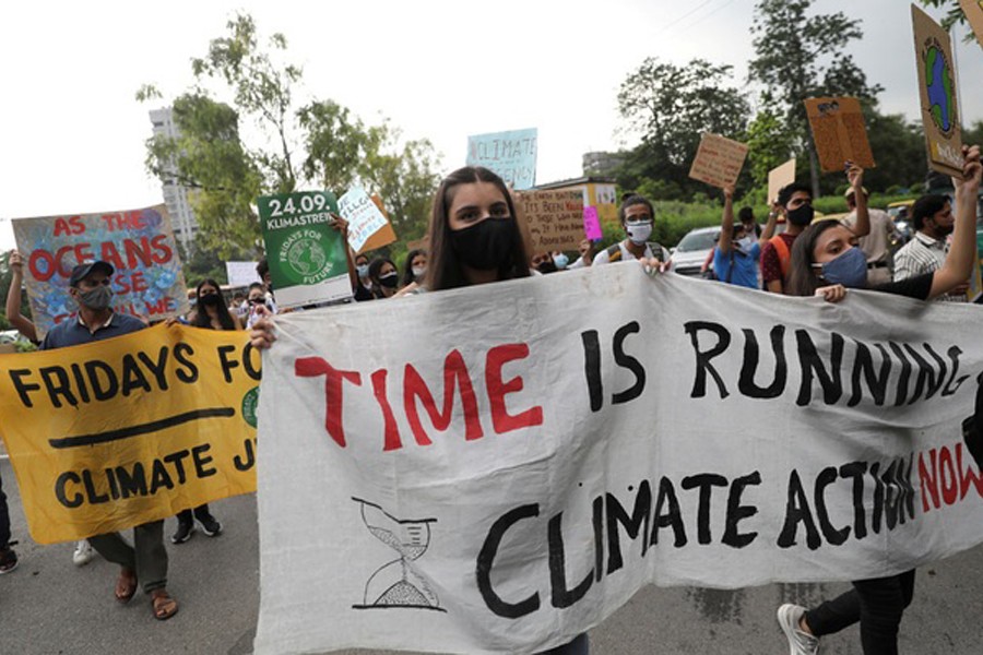 People hold banners and signs as they take part in a "Fridays for Future" march calling for urgent measures to combat climate change, in New Delhi, India, September 24, 2021. Reuters