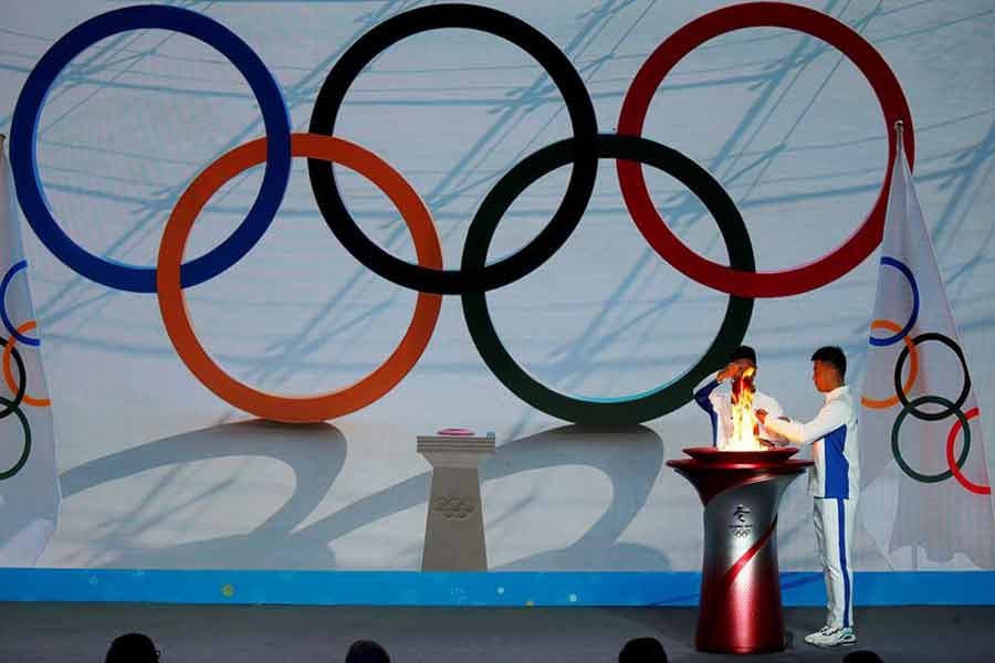 Participants transferring the Olympic flame from a cauldron at the ceremony to welcome the flame for the Beijing 2022 Winter Olympics, in Beijing of China on October 20 this year –Reuters file photo