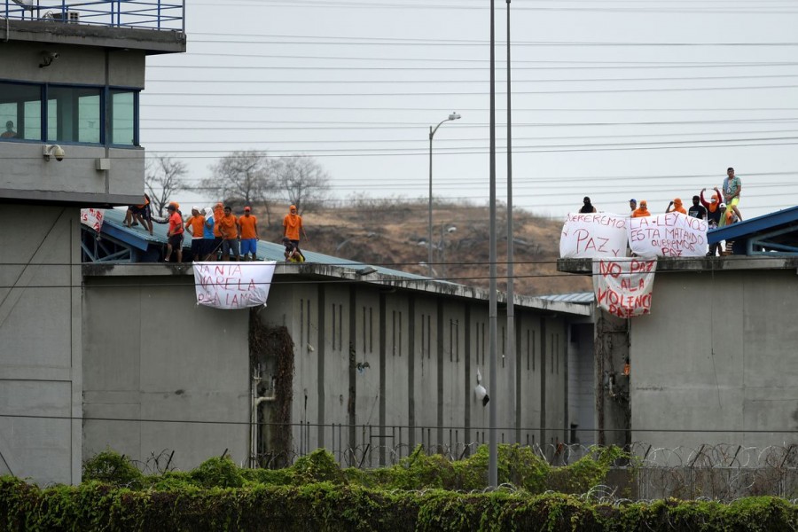 Inmates of the Regional de Guayaquil prison hold banners reading "We want peace," "The law is killing us," "Peace, no to violence" after unrest was reported since the country's worst-ever riots broke out a few days ago at the Penitenciaria del Litoral, in Guayaquil, Ecuador October 2, 2021. REUTERS/Vicente Gaibor del Pino/File Photo/File Photo