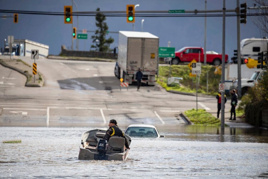 A volunteer operating a rescue boat on Tuesday in Abbotsford, British Columbia. Credit - Darryl Dyck/The Canadian Press, via Associated Press