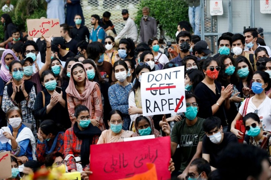 People carry signs against a gang rape that occurred along a highway and to condemn violence against women and girls, during a protest in Karachi, Pakistan Sept 12, 2020. REUTERS/Akhtar Soomro