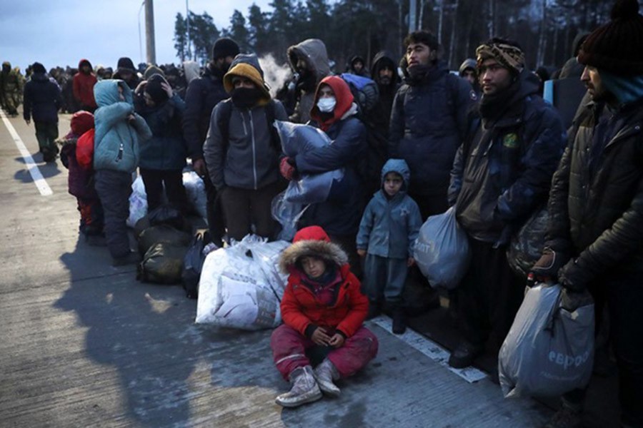 Migrants gather at a transport and logistics centre near the Belarusian-Polish border in the Grodno region, Belarus, November 18, 2021. REUTERS/Kacper Pempel