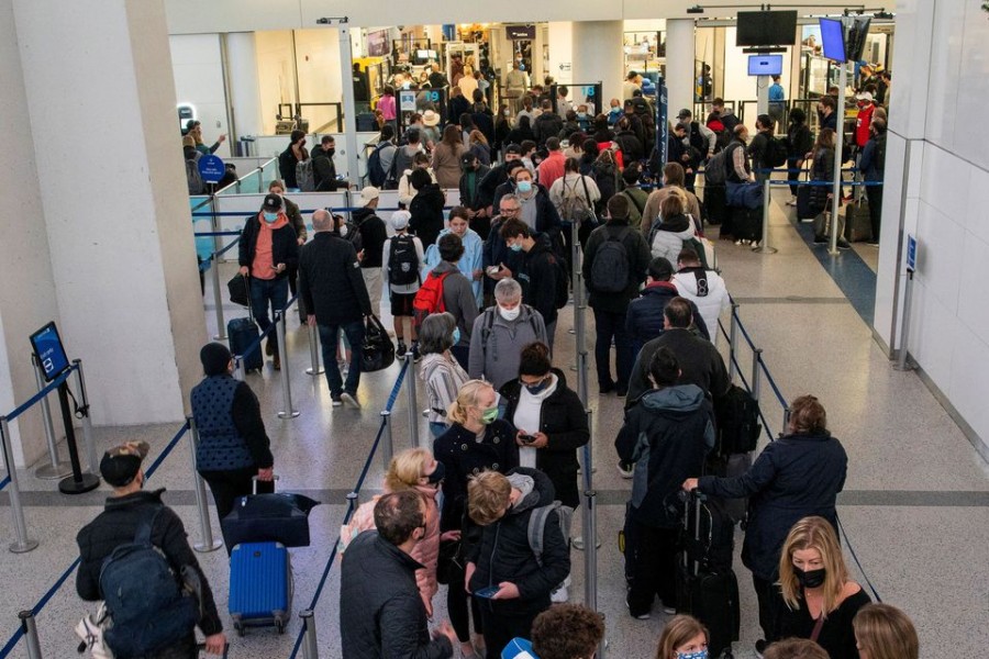 Passengers wait in line inside the terminal at Newark Liberty International Airport in Newark, New Jersey, US on November 24, 2021 — Reuters/Files