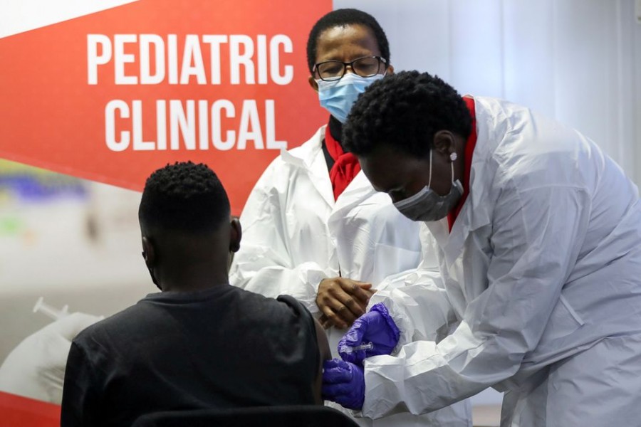 A health worker administers a vaccine during the launch of the South African leg of a global Phase III trial of Sinovac's COVID-19 vaccination of children and adolescents, in Pretoria, South Africa, September 10, 2021. REUTERS/Siphiwe Sibeko