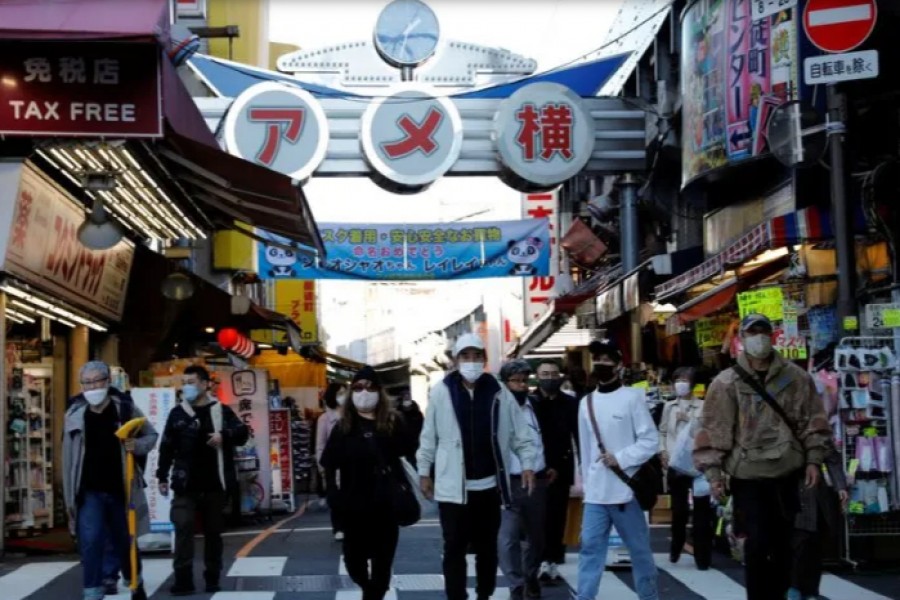 Pedestrians wearing protective masks, amid the coronavirus disease (COVID-19) outbreak, make their way at the Ameyoko shopping district in Tokyo - Reuters