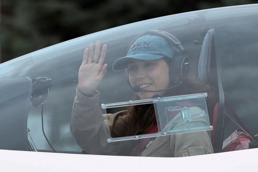 Belgian-British pilot Zara Rutherford, 19, waves as she departs for a round-the-world trip in a light aircraft, aiming to become the youngest female pilot to circle the planet alone, in Wevelgem, Belgium, August 18, 2021. REUTERS/Yves Herman