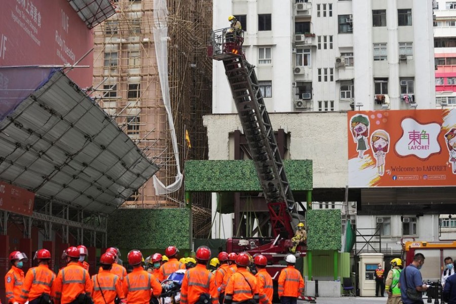 Firefighters operate an extendable ladder to rescue people trapped in a fire that broke out at the World Trade Centre in Hong Kong, China on December 15, 2021 — Reuters photo