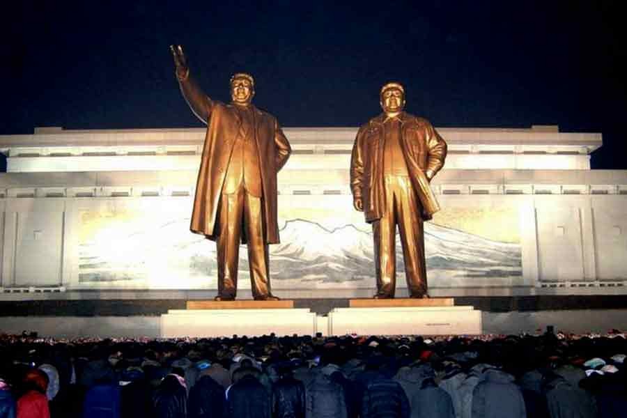 North Koreans paying respects in front of statues of North Korea's founder Kim Il Sung and former leader Kim Jong Il at Mansudae hill in Pyongyang, on the second anniversary of the death of Kim Jong Il, on December 17 in 2013 -Photo: REUTERS/KCNA