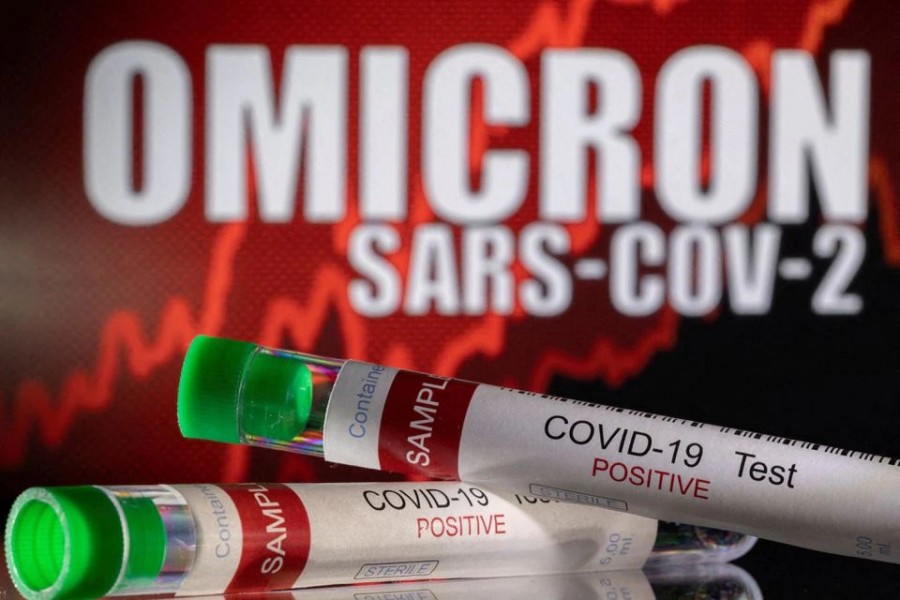 Test tubes labelled "Covid-19 Test Positive" are seen in front of displayed words "OMICRON SARS-COV-2" in this illustration taken on December 11, 2021 — Reuters illustration