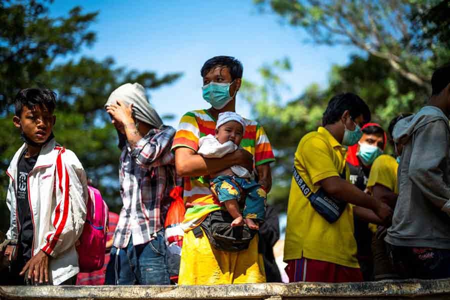 Refugees, who fled a flare-up in fighting between the Myanmar army and ethnic minority rebels prepare, returning across the border to Myanmar through Mae Sot district in Tak province of Thailand on Sunday –Reuters file photo