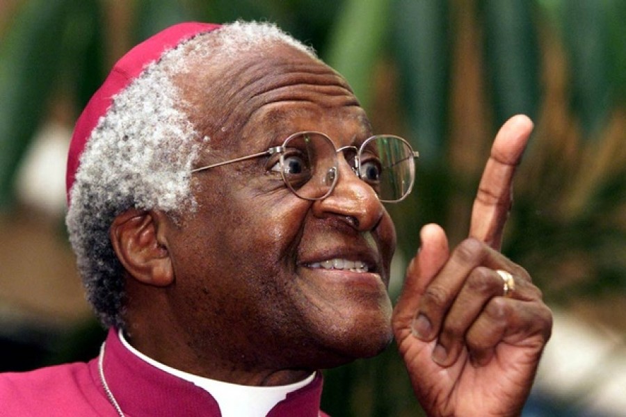 Archbishop Desmond Tutu makes a point as he addresses a meeting March 16, 2001 to raise awareness for World Tuberculosis Day. [Tutu, who suffered from tuberculosis as a child, said that TB was not simply a medical problem, but one that was rooted in social, political and economic issues. He told members of the Uitsig community near Cape Town that being cured of TB was a basic human right and not a privilege as the disease was curable. World Tuberculosis Day is March 24 – Reuters/Mike Hutchings/File Photo