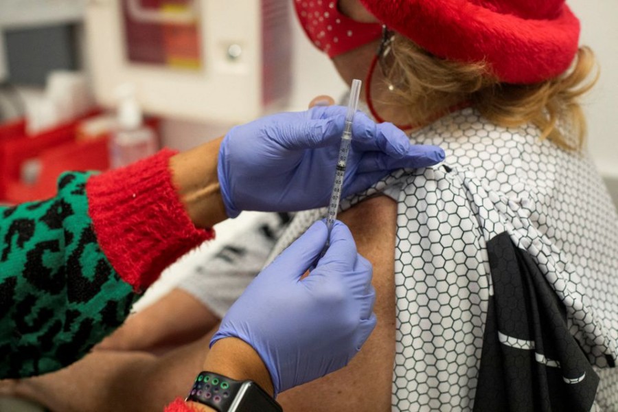 A nurse prepares to administer the coronavirus disease (COVID-19) vaccine booster at the North Oakland Health Center in Pontiac, Michigan, U.S., December 21, 2021. REUTERS/Emily Elconin