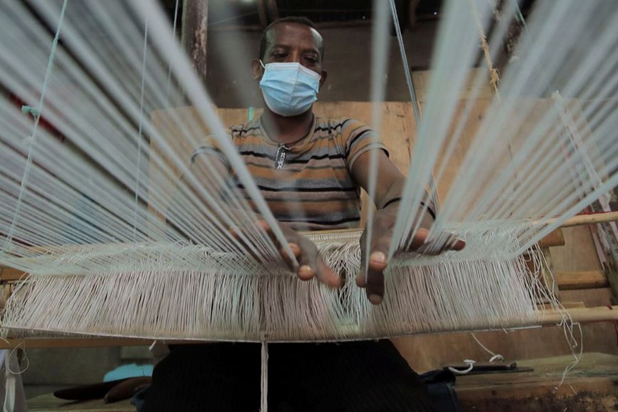 Tadele Abate, 37, weaves a fabric at the Sammy Ethiopia hand made garments, hand-woven textiles and basketry factory in Addis Ababa, Ethiopia on October 14, 2021 — Reuters/Files