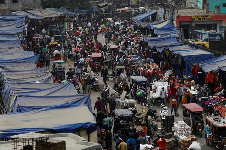 People shop at a crowded market amidst the spread of the coronavirus disease (Covid-19), in the old quarters of Delhi, India on January 4, 2022