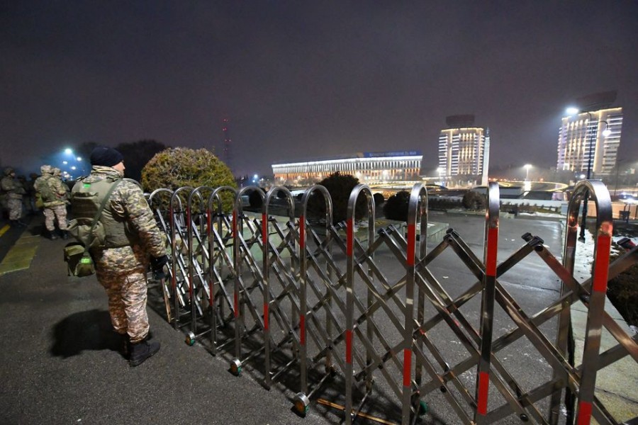 Law enforcement officers stand guard in front of the mayor's office during protests triggered by fuel price increase in Almaty, Kazakhstan on January 5, 2022 — via Reuters