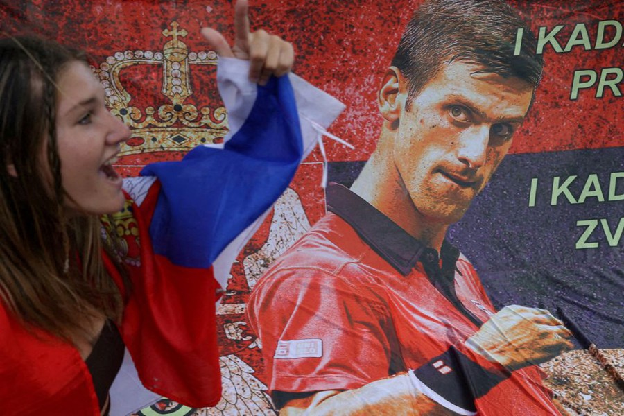 A supporter of Serbian tennis player Novak Djokovic rallies outside the Park Hotel, where the star athlete is believed to be held while he stays in Australia, in Melbourne, Australia on January 7, 2022 — Reuters photo