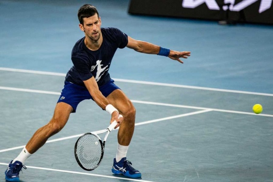 Serbian tennis player Novak Djokovic practices at Melbourne Park as questions remain over the legal battle regarding his visa to play in the Australian Open in Melbourne, Australia, January 14, 2022 –Diego Fedele via Reuters