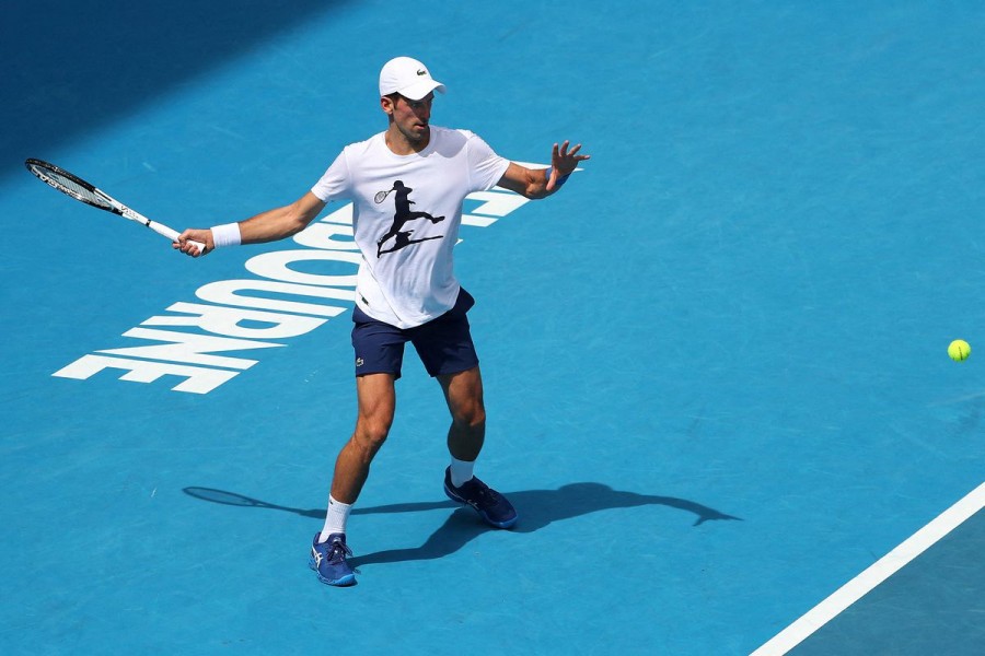 Serbian tennis player Novak Djokovic practices on Rod Laver Arena ahead of the 2022 Australian Open at Melbourne Park, in Melbourne, Australia, January 11, 2022. Kelly Defina/Pool via REUTERS