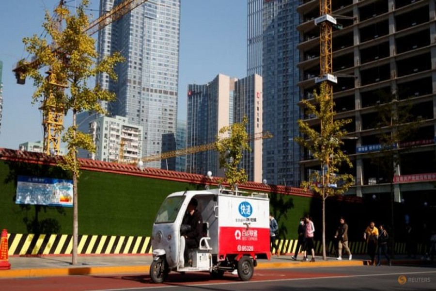 An electric delivery vehicle drives in the Central Business District in Beijing, China October 29, 2019 — Reuters/Thomas Peter