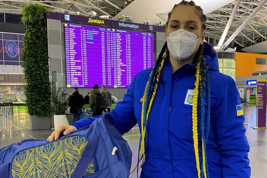 Ukrainian bobsledder, Lidiia Hunko, poses next to her luggage at Boryspil International Airport, in Kyiv Oblast, Ukraine, in this picture obtained from social media that was uploaded on January 29, 2022.