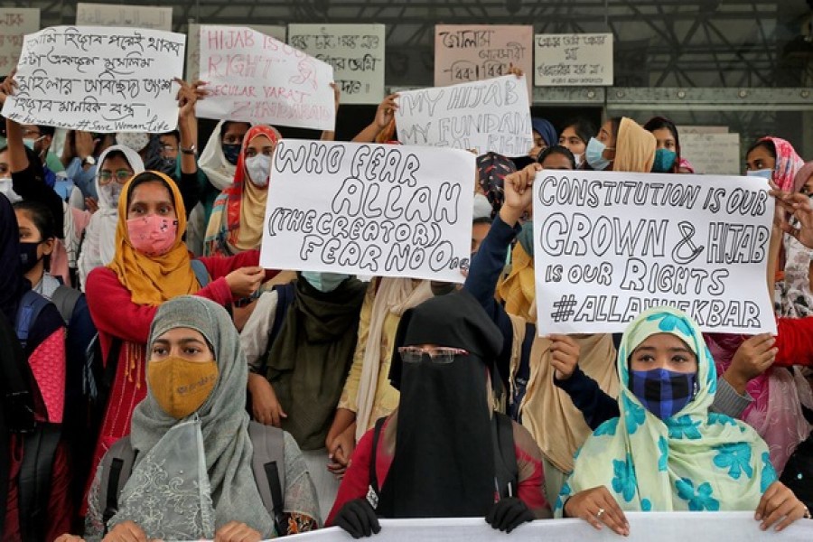 Muslim students display placards during a protest against the recent hijab ban in few colleges of Karnataka state, at Aliah University in Kolkata, India, Feb 9, 2022 – Reuters/Rupak De Chowdhuri