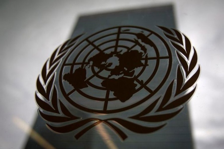 A United Nations logo is seen on a glass door in the Assembly Building at the United Nations headquarters in New York City September 18, 2015. REUTERS/Mike Segar