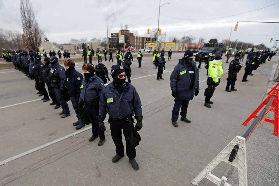 Police officers hold a line, on the road leading to the Ambassador Bridge, which connects Detroit and Windsor, after clearing demonstrators, during a protest against coronavirus disease (Covid-19) vaccine mandates, in Windsor, Ontario, Canada on February 13, 2022 — Reuters photo