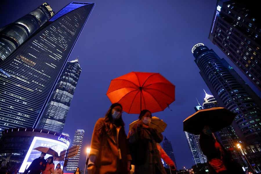 People walking with umbrellas in Lujiazui financial district in Pudong of Shanghai on the day of the opening session of the National People's Congress (NPC) of China on March 5 last year –Reuters file photo