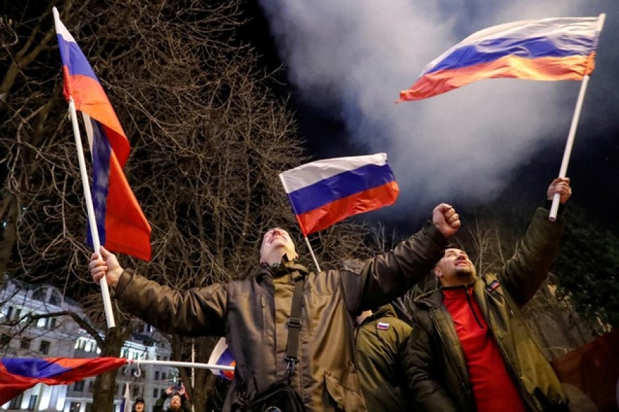 Pro-Russian activists react on a street as fireworks explode in the sky, after Russian President Vladimir Putin signed a decree recognising two Russian-backed breakaway regions in eastern Ukraine as independent entities, in the separatist-controlled city of Donetsk, Ukraine February 21, 2022 — Reuters/Alexander Ermochenko