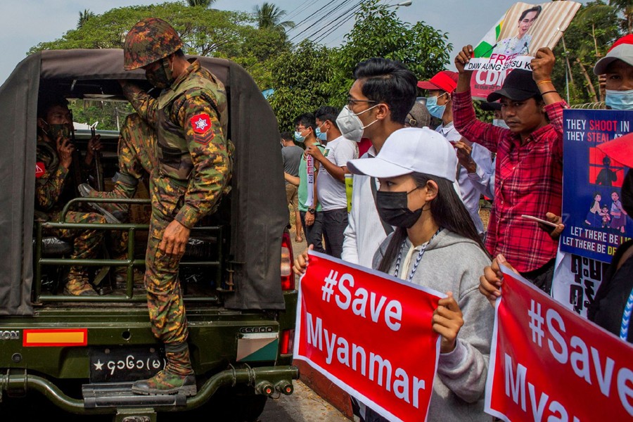 A soldier steps out of a military vehicle outside Myanmar's Central Bank during a protest against the military coup, in Yangon, Myanmar on February 15, 2021 — Reuters/Files