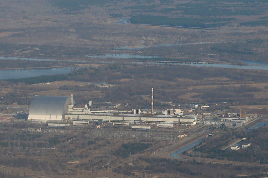 An aerial view from a plane shows a New Safe Confinement (NSC) structure over the old sarcophagus covering the damaged fourth reactor at the Chernobyl Nuclear Power Plant during a tour to the Chernobyl exclusion zone, Ukraine on April 3, 2021 — Reuters/Files